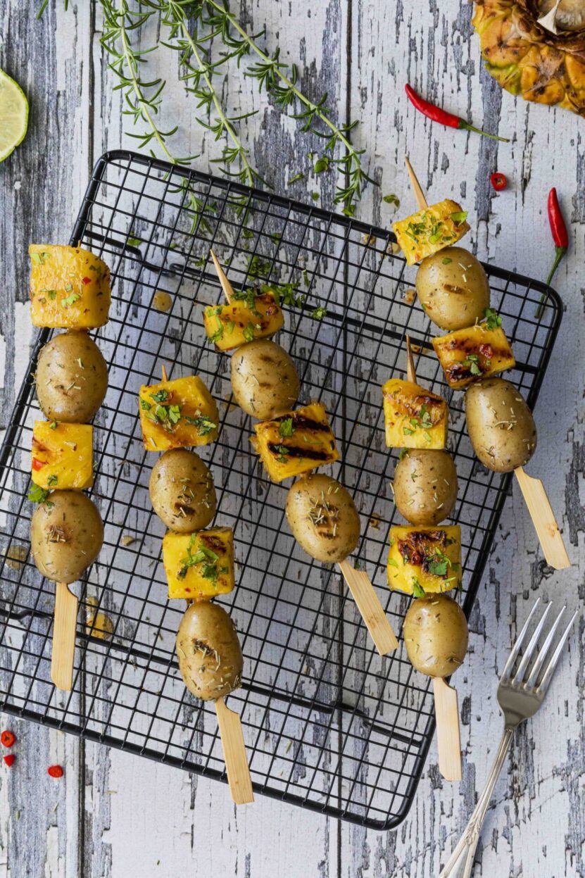 Baby potato skewers and spicy pineapple grilled on the BBQ